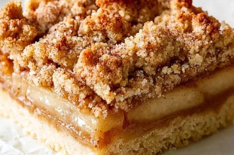 Delicious Apple Crisp Bars with oats and cinnamon on a wooden plate.