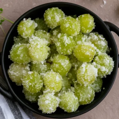 A bowl of candied frozen sour grapes ready to be enjoyed as a sweet snack