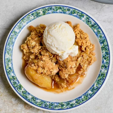 Delicious homemade apple crumble with crispy topping served in a bowl