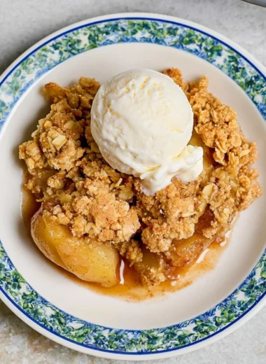 Delicious homemade apple crumble with crispy topping served in a bowl