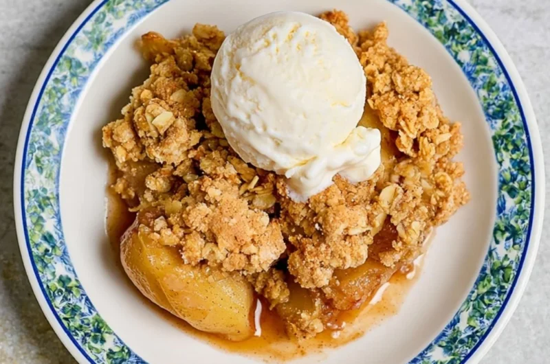 Delicious homemade apple crumble with crispy topping served in a bowl