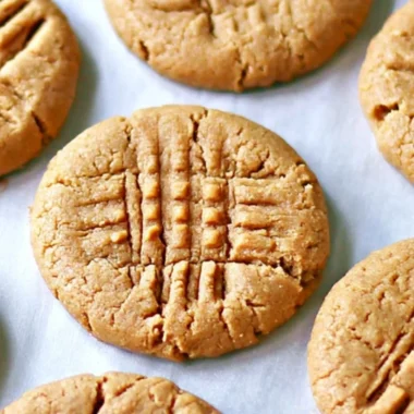 Three delicious homemade peanut butter cookies on a plate.
