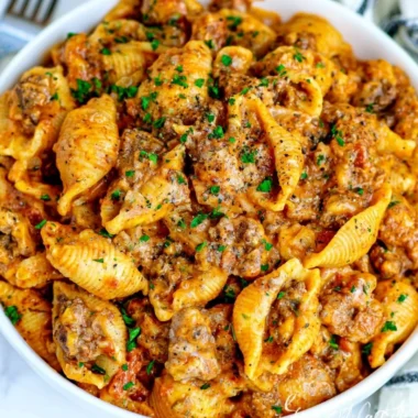 Delicious bowl of creamy beef and shells topped with parsley