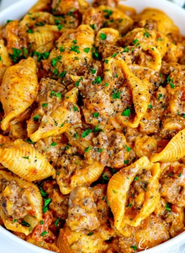 Delicious bowl of creamy beef and shells topped with parsley
