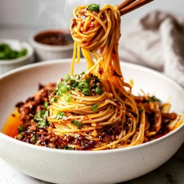 Bowl of Cozy Szechuan Noodles with colorful vegetables and spicy sauce