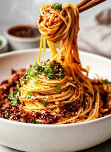 Bowl of Cozy Szechuan Noodles with colorful vegetables and spicy sauce