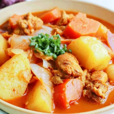 Delicious Dakbokkeumtang Korean chicken stew garnished with herbs and vegetables.