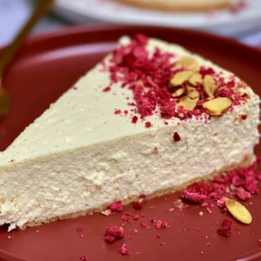 Slice of diabetic cheesecake topped with fresh berries and a light drizzle.