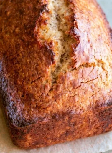 Freshly baked easy banana bread loaf on a wooden cutting board
