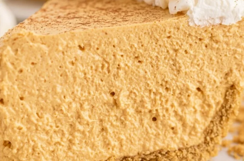 Fluffy Marshmallow Pumpkin Pie topped with whipped cream and spices
