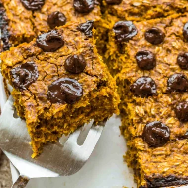 Bowl of pumpkin baked oatmeal with chocolate chips topped with nuts