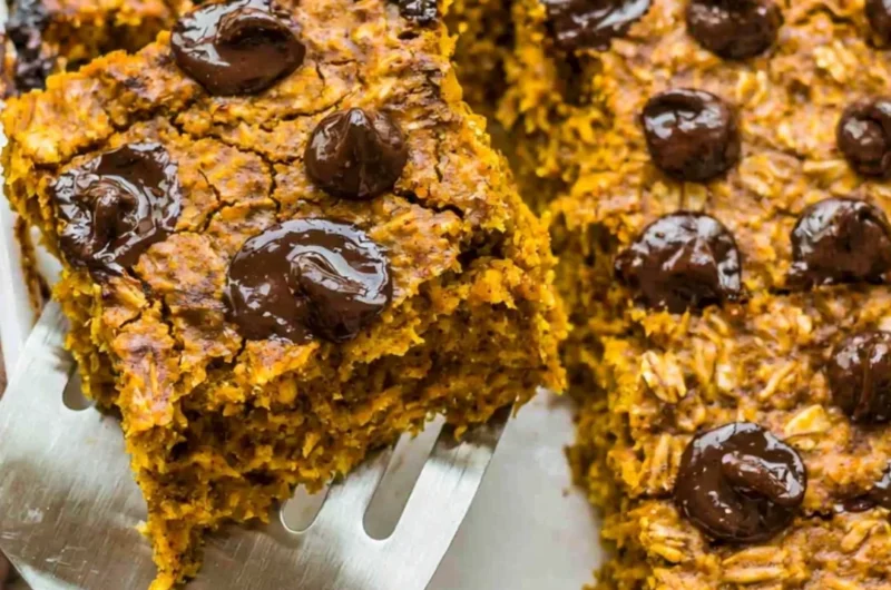 Bowl of pumpkin baked oatmeal with chocolate chips topped with nuts