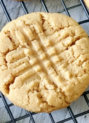 Batch of soft peanut butter cookies cooling on a wire rack