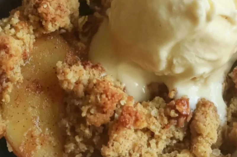 Delicious sugar free apple crisp dessert served in a bowl with a scoop of ice cream.