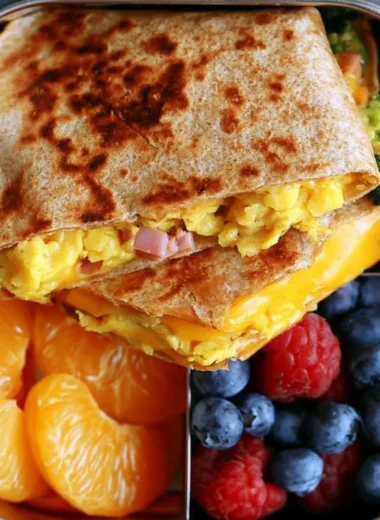 Delicious breakfast quesadilla filled with eggs, cheese, and veggies on a plate