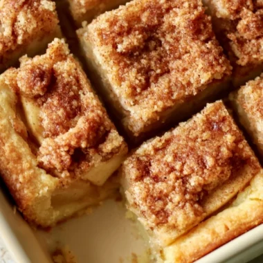 Delicious cozy apple pie bars served with caramel drizzle and cinnamon on top.