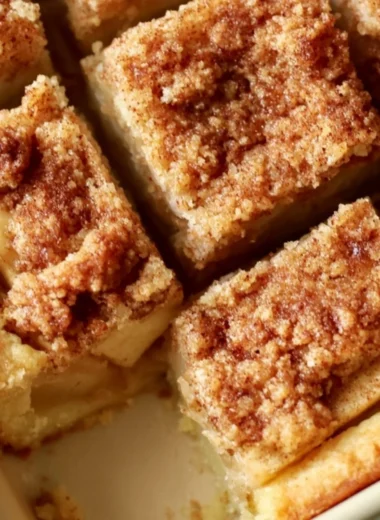 Delicious cozy apple pie bars served with caramel drizzle and cinnamon on top.