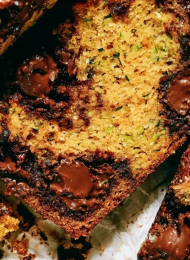 Loaf of cozy chocolate chip zucchini bread garnished with chocolate chips.