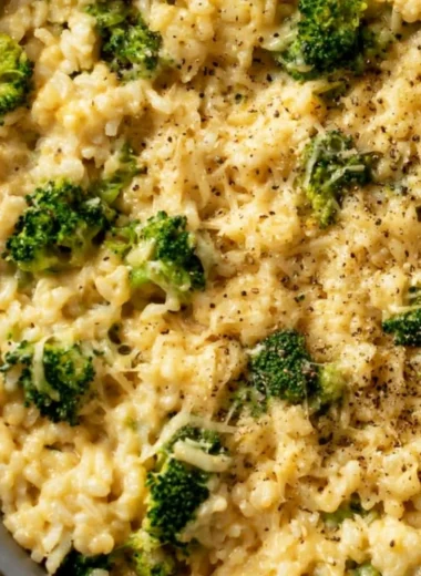 Cozy Creamy Broccoli Cheese Rice served in a bowl with cheese and broccoli visible