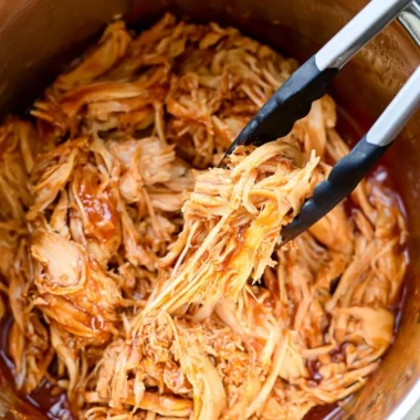Instant Pot BBQ chicken dish served with sides and garnished.