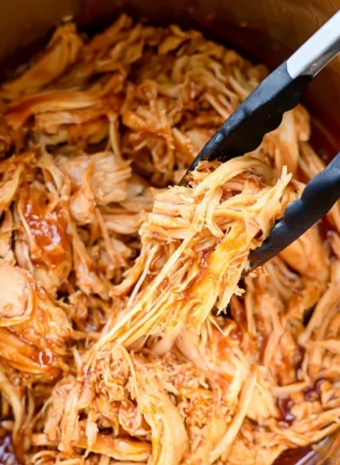 Instant Pot BBQ chicken dish served with sides and garnished.