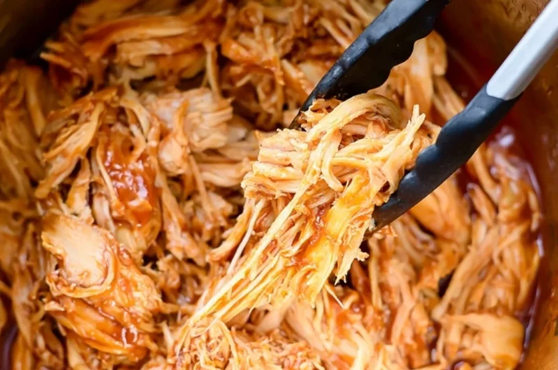 Instant Pot BBQ chicken dish served with sides and garnished.