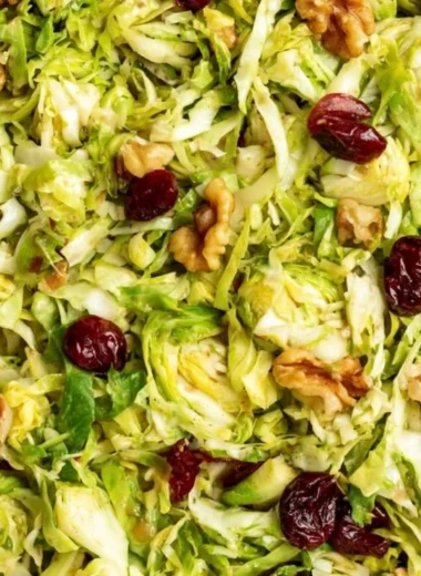 Cozy shaved Brussels sprouts salad with colorful toppings and dressing.