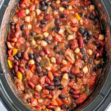 Bowl of cozy slow cooker vegetarian chili topped with fresh herbs