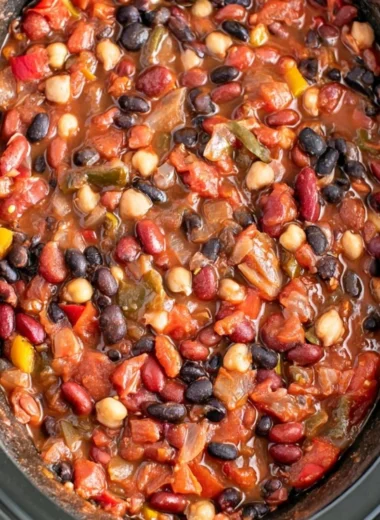 Bowl of cozy slow cooker vegetarian chili topped with fresh herbs