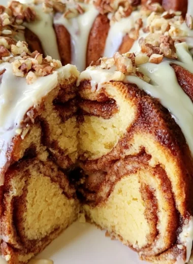 Easy Cinnamon Roll Bundt Cake with icing on a serving plate