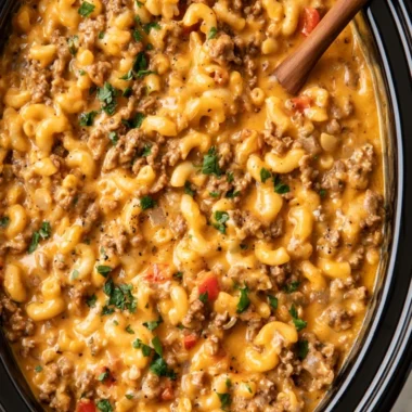 Bowl of slow cooker hamburger helper served with a side of vegetables