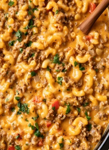 Bowl of slow cooker hamburger helper served with a side of vegetables