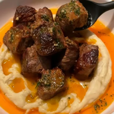 Delicious Cowboy Butter Steak Bites topped with caramelized onions