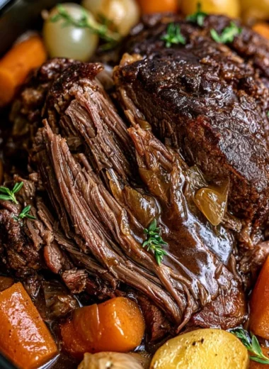 A delicious cozy crockpot pot roast served with vegetables in a warm bowl.