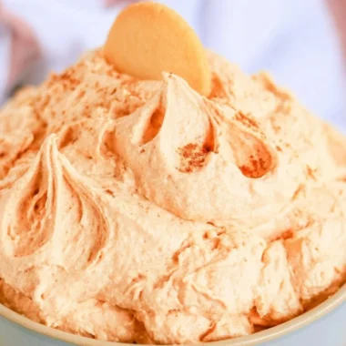 Easy five-ingredient pumpkin cheesecake dip served in a bowl with graham crackers.