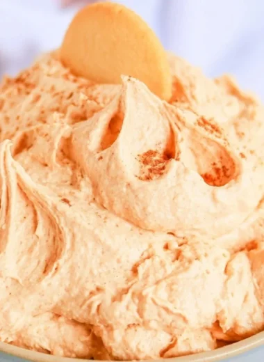 Easy five-ingredient pumpkin cheesecake dip served in a bowl with graham crackers.