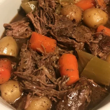 Easy slow cooker pot roast with vegetables served on a plate